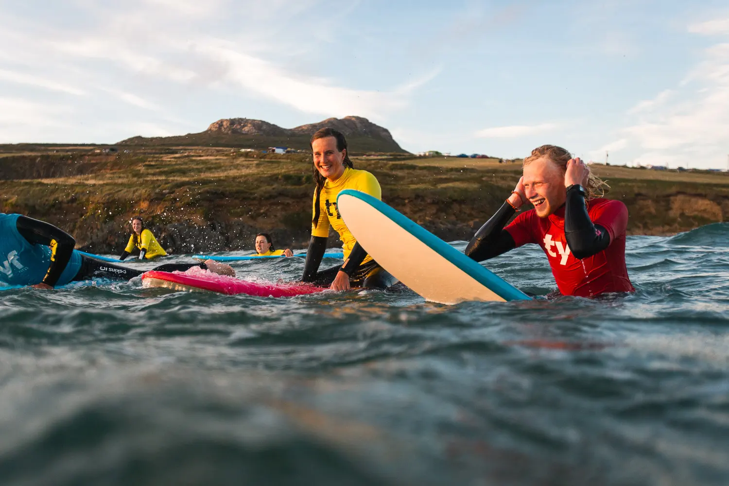 A Group enjoying time togeather in the surf waiting for the next wave