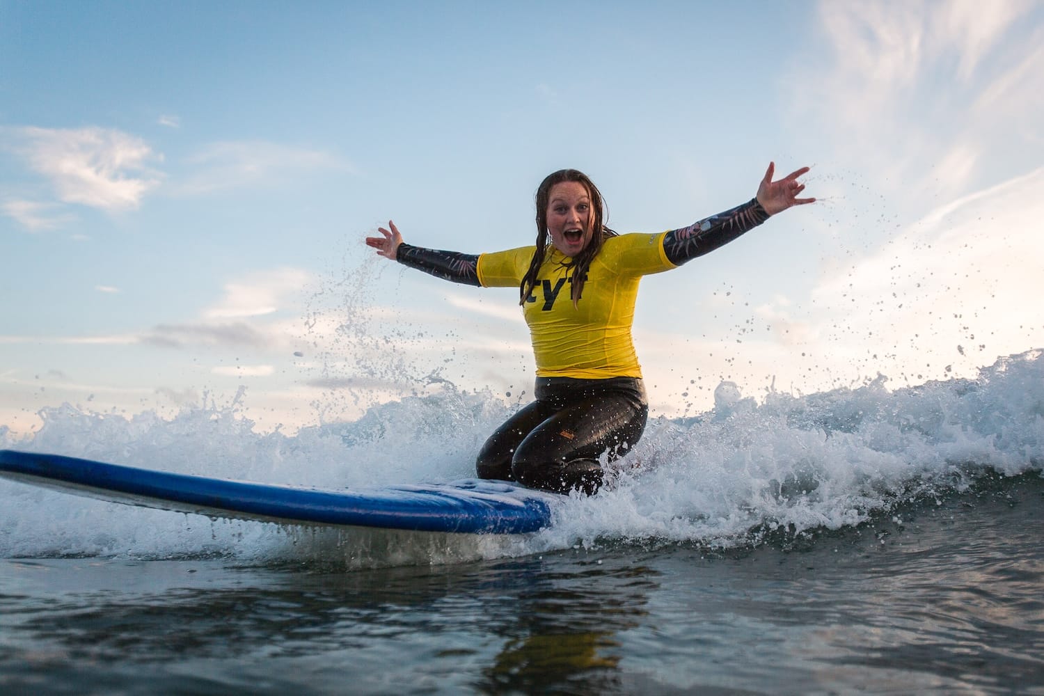Mum on surfing session riding a wave on her knees