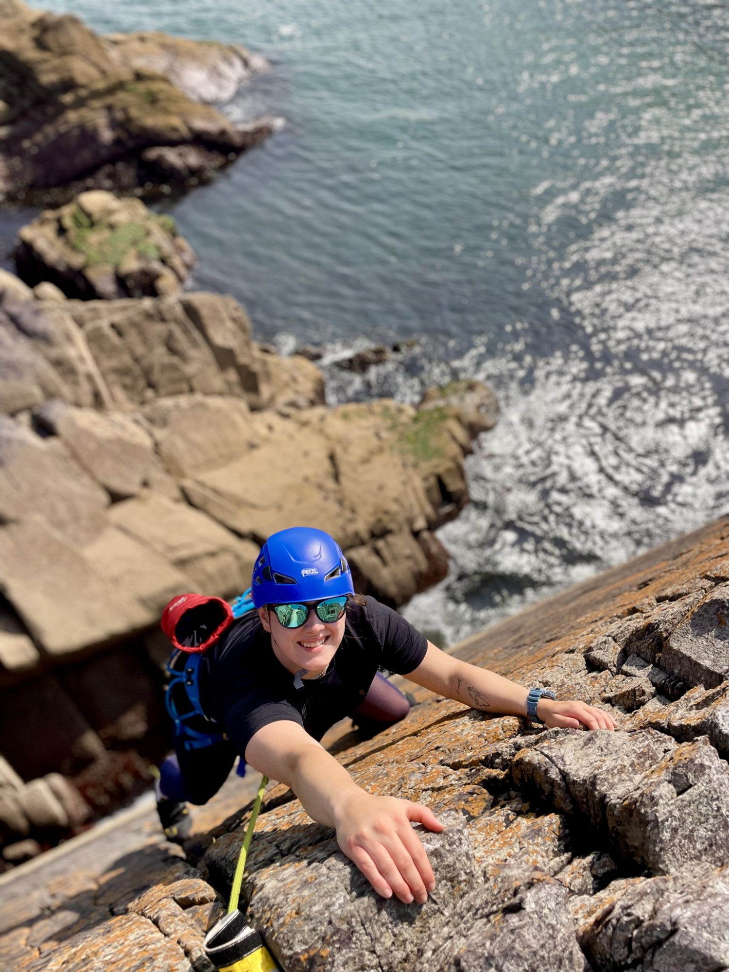 Trainee outdoor instructors learning climbing skills in Pembrokeshire