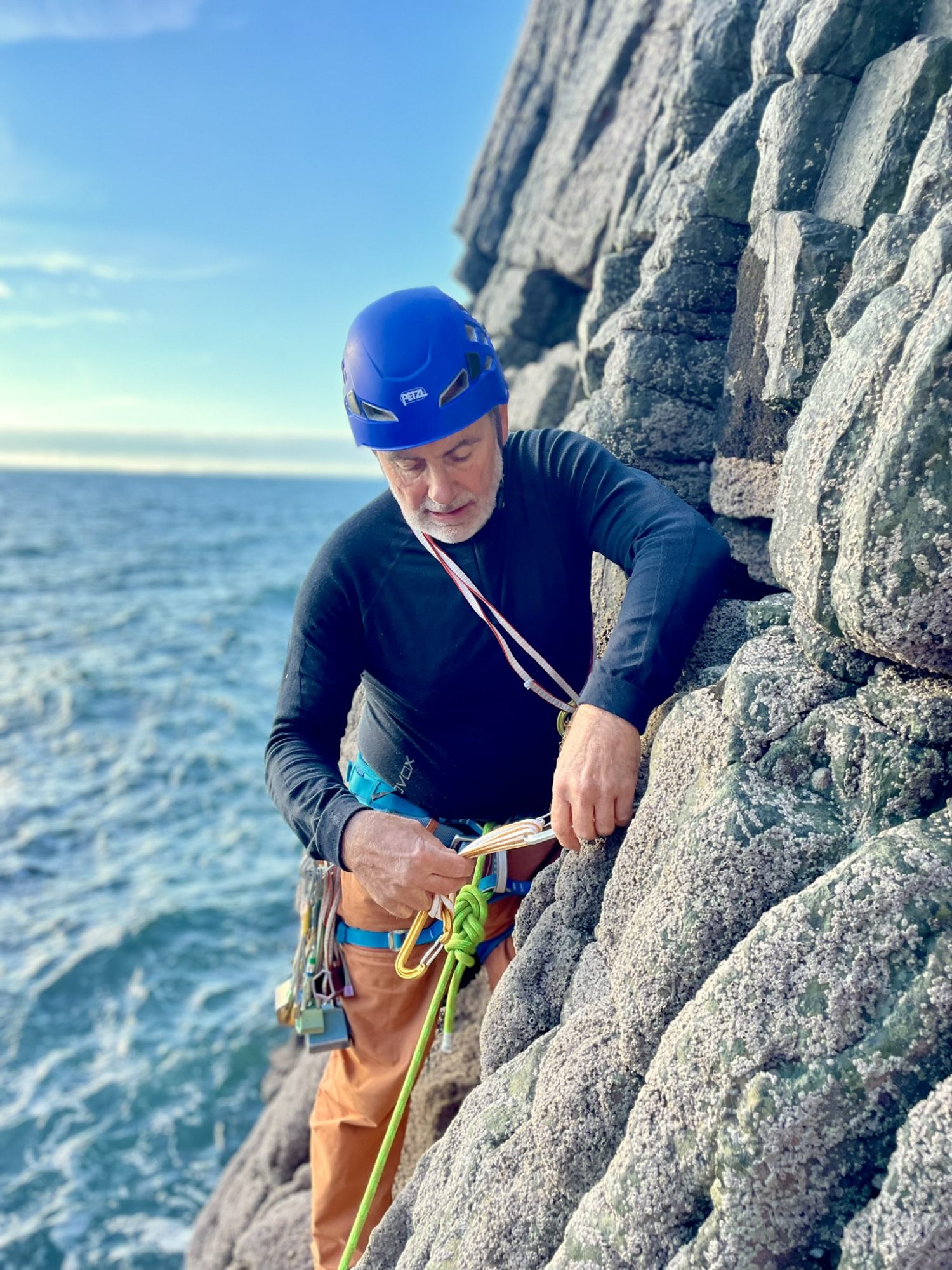 Outdoor instructor training rope systems on a coastal rock climb